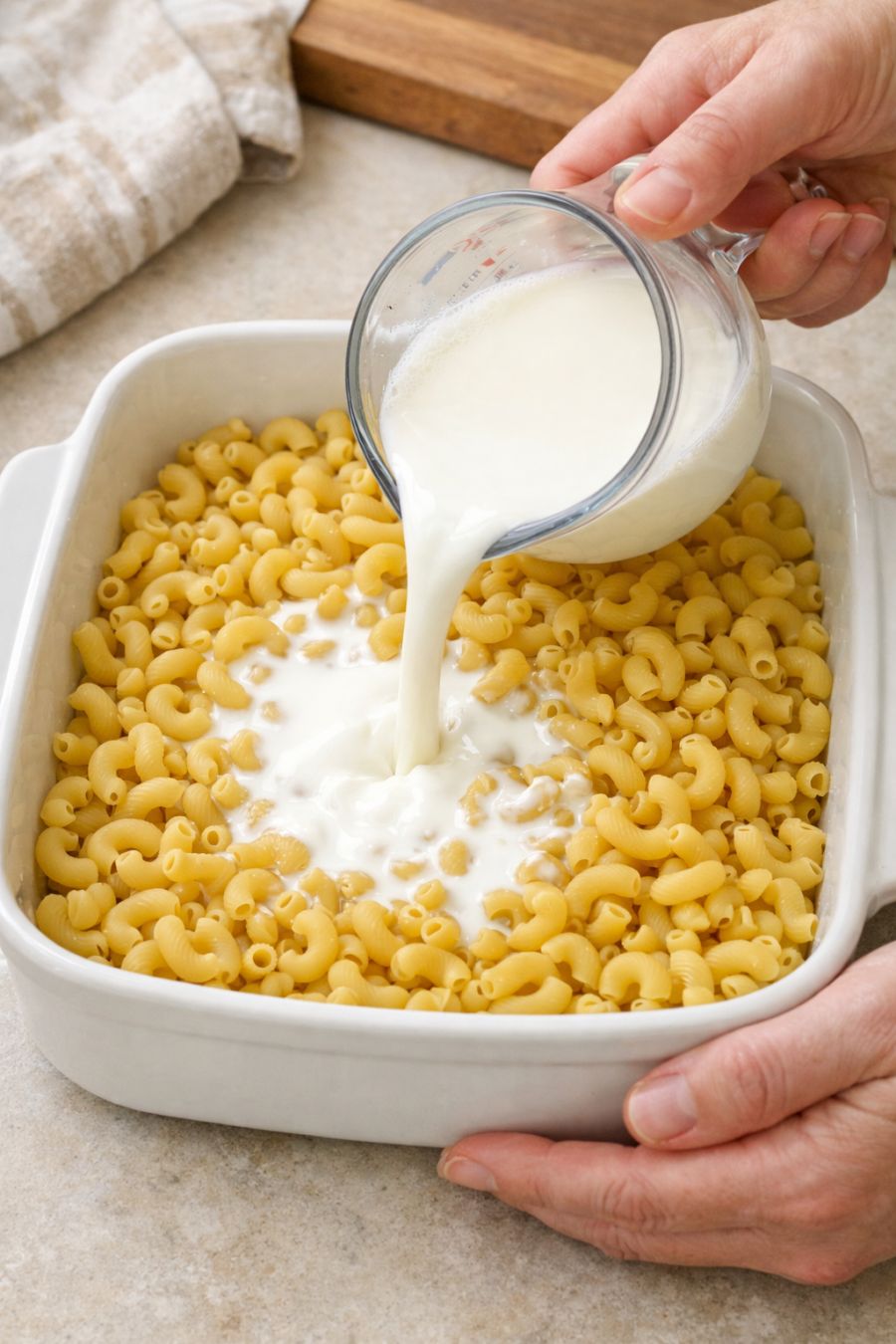Pour cold whole milk over raw dry elbow macaroni, paired with 3 pantry staples, into a ceramic casserole dish for a creamy meal that’s my default when I don’t know what to make